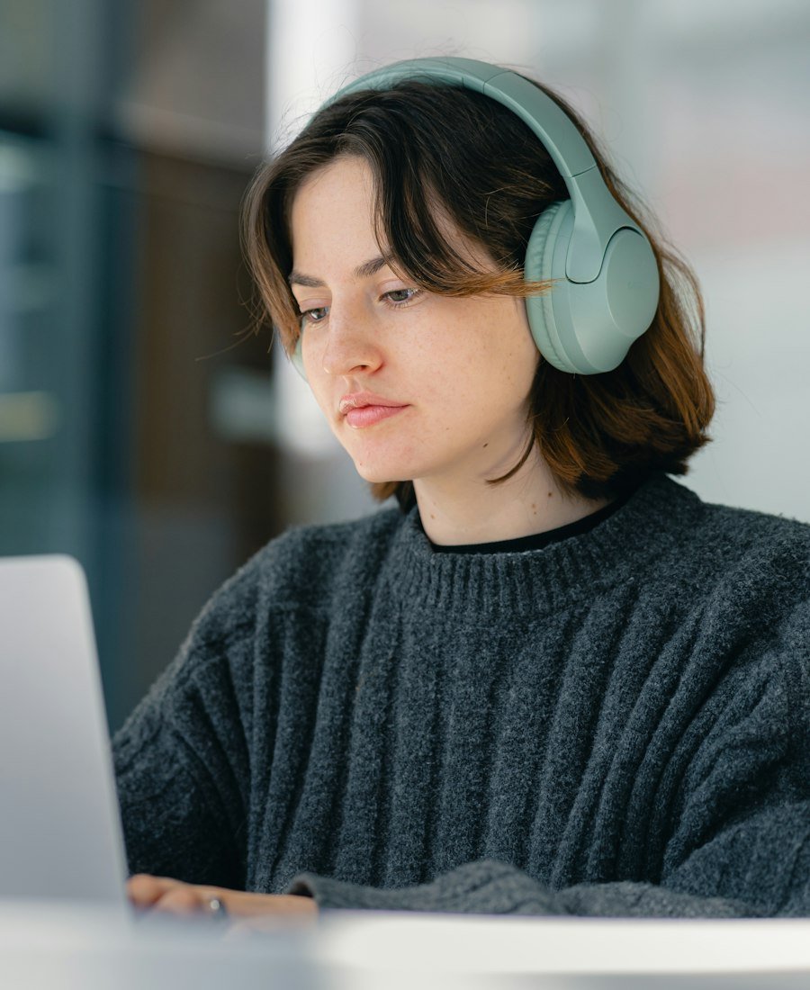 A learner studying online with headphones